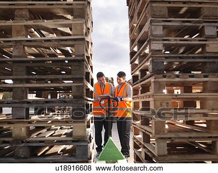 Stock Photo - Workers with pallets and pallet truck. Fotosearch