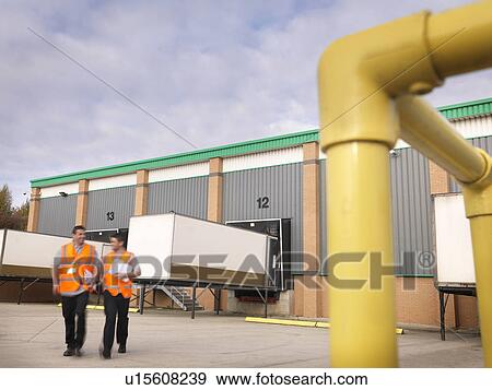 Stock Photo - Workers with truck containers. Fotosearch