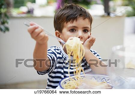 Young boy eating spaghetti View Large Photo Image Picture - Young boy eating spaghetti. Fotosearch
