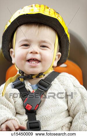 Stock Photo - Young boy laughing in cycle seat. Fotosearch