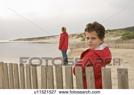 Stock Photo - Young boy looking at camera seriously. Fotosearch