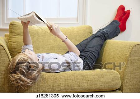 Young boy reading in an armchair View Large Photo Image Stock Photography - Young boy reading in an armchair. Fotosearch