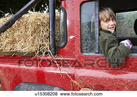 Stock Photo - Young boy smiling in the back of 4x4. Fotosearch