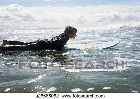 Young boy surfing View Large Photo Image Stock Image - Young boy surfing. Fotosearch