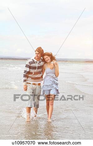 Stock Image - Young couple taking a romantic walk. Fotosearch