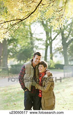Stock Photo - Young couple walking in autumn park. Fotosearch