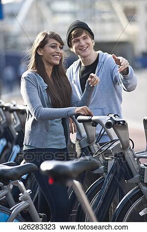 Stock Image - Young couple with bicycles. Fotosearch