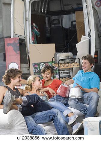 Young couples relax with moving truck View Large Photo Image Stock Photograph - Young couples relax with moving truck. Fotosearch