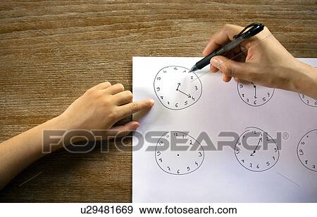 Young girl learning to read the time View Large Photo Image Stock Photo - Young girl learning to read the time. Fotosearch