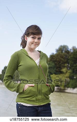 Young girl listening to ipod near river View Large Photo Image Stock Photography - Young girl listening to ipod near river. Fotosearch