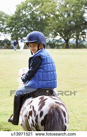 Young girl riding her pony View Large Photo Image Stock Image - Young girl riding her pony. Fotosearch