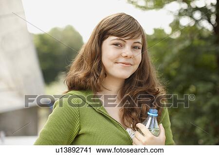 Young girl smiling at camera with water View Large Photo Image Stock Image - Young girl smiling at camera with water. Fotosearch