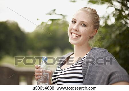 Young girl smiling at camera with water View Large Photo Image Stock Photo - Young girl smiling at camera with water. Fotosearch
