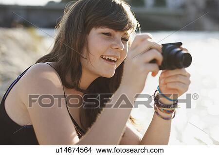 Young girl taking a picture and laughing View Large Photo Image Picture - Young girl taking a picture and laughing. Fotosearch