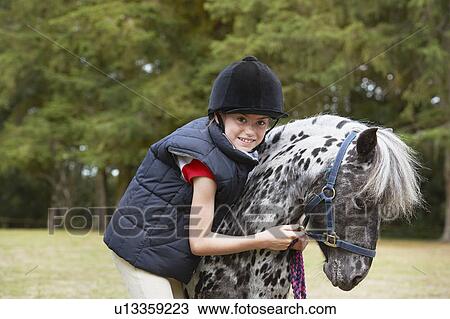 Young girl with pony View Large Photo Image Stock Image - Young girl with pony. Fotosearch