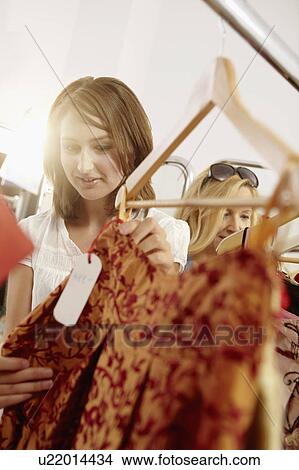 Young lady fascinated in fashion store View Large Photo Image Picture - Young lady fascinated in fashion store. Fotosearch