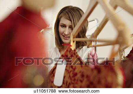 Young lady fascinated in fashion store View Large Photo Image Stock Photo - Young lady fascinated in fashion store. Fotosearch