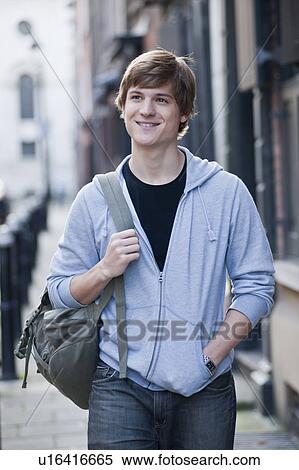 Stock Photography - Young male walking and smiling. Fotosearch