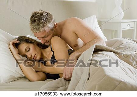 Young man embraces sleeping woman View Large Photo Image Stock Image - Young man embraces sleeping woman. Fotosearch