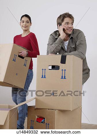 Stock Image - Young man phones during removal. Fotosearch