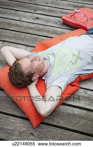 Young man relaxing View Large Photo Image Stock Photography - Young man relaxing. Fotosearch