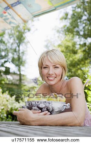 Young woman holding a bowl with apples View Large Photo Image Stock Photography - Young woman holding a bowl with apples. Fotosearch