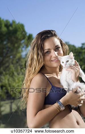 Young woman holds white kitten outside View Large Photo Image Picture - Young woman holds white kitten outside. Fotosearch