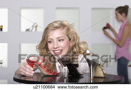 Young woman in shoe shop View Large Photo Image Picture - Young woman in shoe shop. Fotosearch
