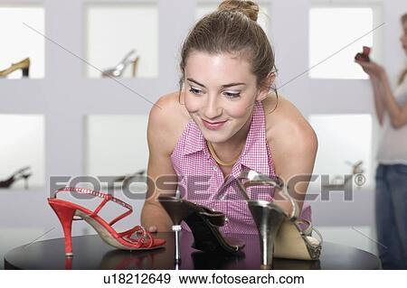 Young woman in shoe shop View Large Photo Image Stock Photo - Young woman in shoe shop. Fotosearch