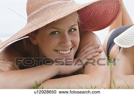 Stock Image - Young woman in straw hat woman smiling. Fotosearch