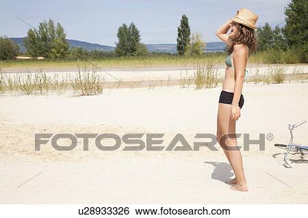 Young woman laughing on a beach View Large Photo Image Stock Photograph - Young woman laughing on a beach. Fotosearch