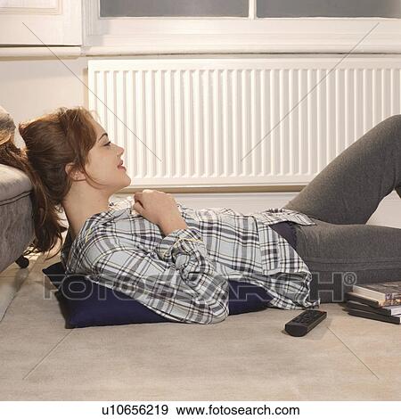 Stock Photo - Young woman lying on floor. Fotosearch