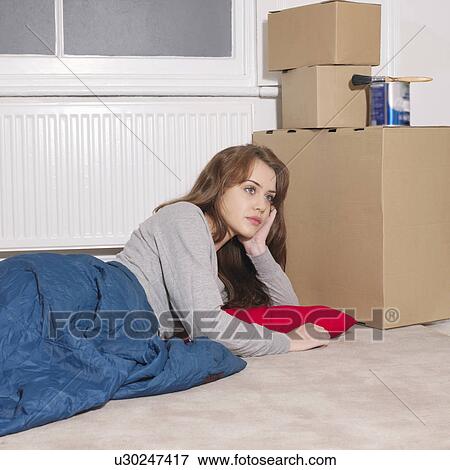 Stock Photo - Young woman next to boxed awake. Fotosearch
