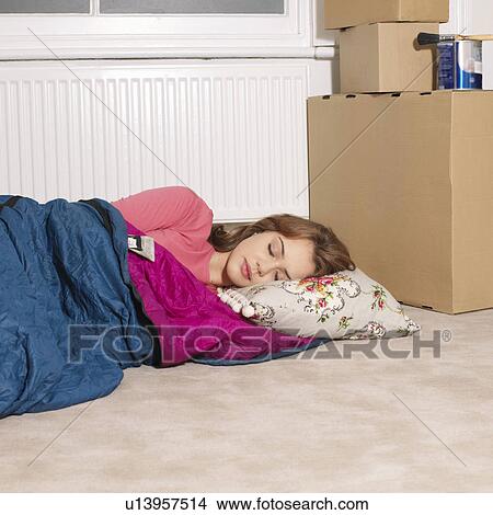 Picture - Young woman next to boxes. Fotosearch