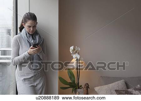Young woman reading text message View Large Photo Image Stock Photo - Young woman reading text message. Fotosearch