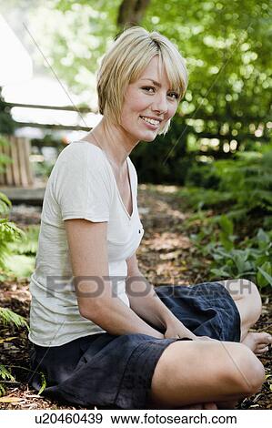Young woman relaxing in garden View Large Photo Image Stock Photo - Young woman relaxing in garden. Fotosearch