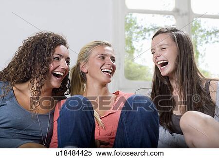 Young woman share a laugh at home View Large Photo Image Stock Photography - Young woman share a laugh at home. Fotosearch