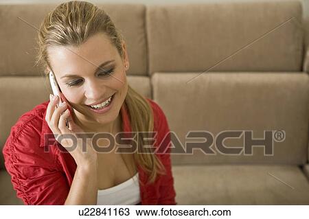 Young woman talking on smartphone View Large Photo Image Stock Image - Young woman talking on smartphone. Fotosearch
