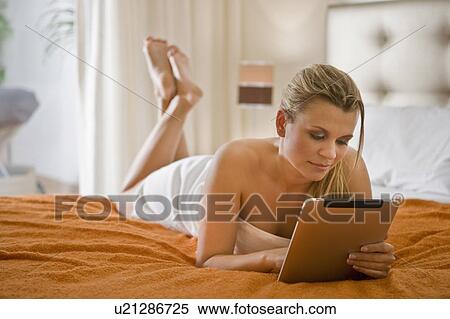 Young woman using tablet computer View Large Photo Image Stock Photography - Young woman using tablet computer. Fotosearch