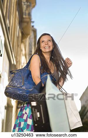 Young woman with shopping bags View Large Photo Image Stock Image - Young woman with shopping bags. Fotosearch