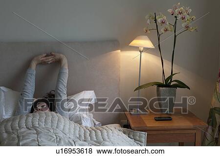 Young woman yawning and stretching View Large Photo Image Stock Photo - Young woman yawning and stretching. Fotosearch