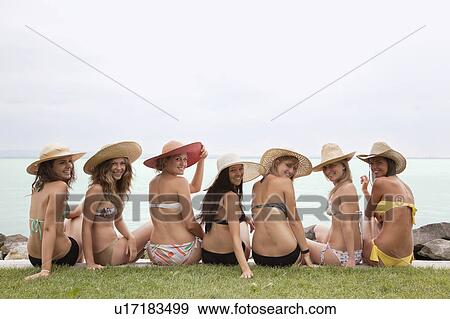 Stock Photo - Young women in bikinis smiling. Fotosearch