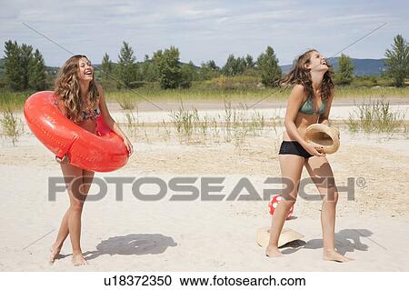 Young women laughing on the beach View Large Photo Image Stock Image - Young women laughing on the beach. Fotosearch