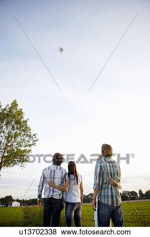 2 couples watching balloons rise in sky View Large Photo Image Stock Photo - 2 couples watching balloons rise in sky. Fotosearch