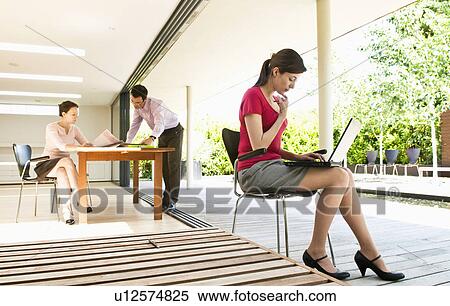 3 business people in modern location View Large Photo Image Stock Photography - 3 business people in modern location. Fotosearch