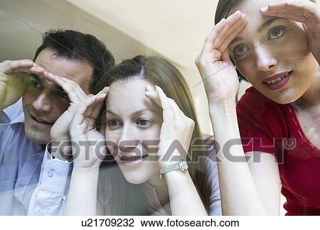 3 colleagues look thru glass View Large Photo Image Stock Image - 3 colleagues look thru glass. Fotosearch