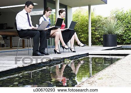 3 colleagues work outdoors View Large Photo Image Stock Image - 3 colleagues work outdoors. Fotosearch