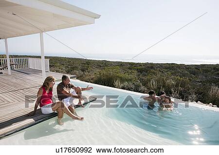 Stock Image - 3 generations by the pool. Fotosearch