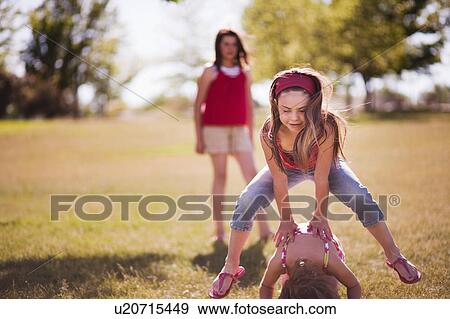 3 girls playing leap frog in park View Large Photo Image Stock Photo - 3 girls playing leap frog in park. Fotosearch