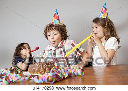 3 kids celebrating birthday party View Large Photo Image Stock Photo - 3 kids celebrating birthday party. Fotosearch